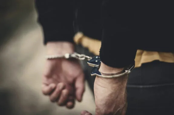 Man in handcuffs behind his back